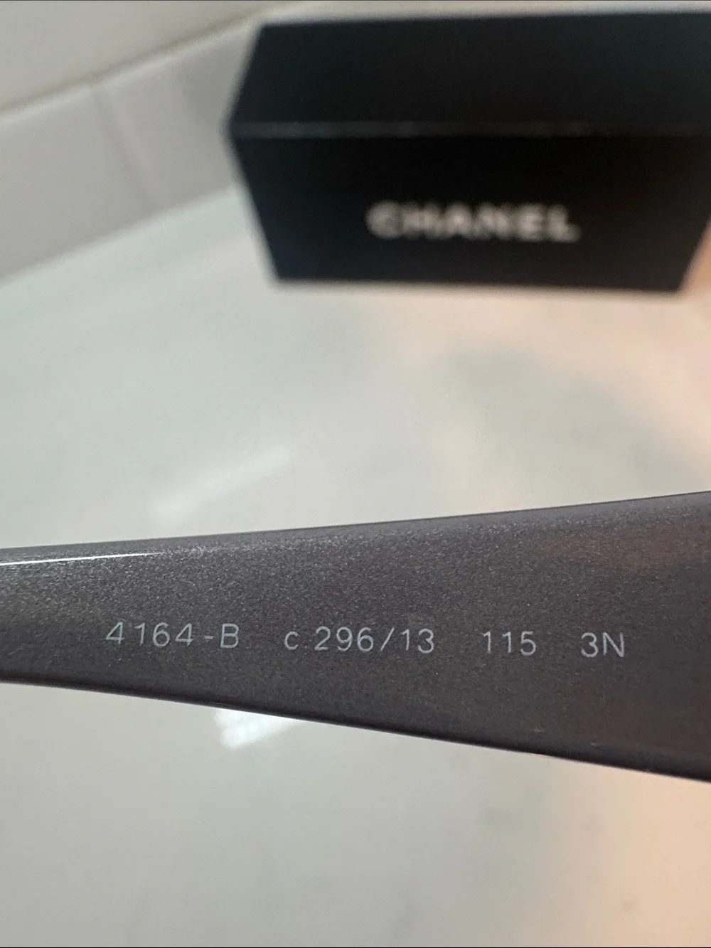 Chanel  Camellia flower with crystal-embellished interlocking CC logo